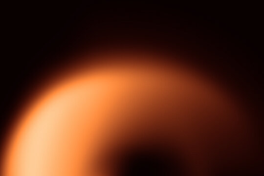 Abstract composition with a deep orange gradient, smoothly spreading across a black background—like fire in velvet night. The orange area forms a partial arc in the lower left.