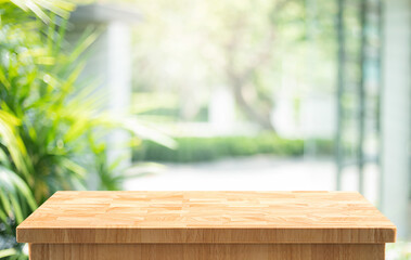 Empty wooden tabletop with a bright, natural blurred and home glass wall background.For showcasing products or presentations.not ai generated