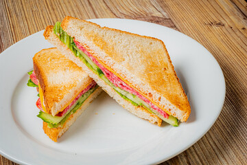 Toasted sandwich with layers of meat and crisp vegetables presents a tempting lunch option