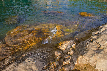 rocky Adriatic coastline with clear water in close-up