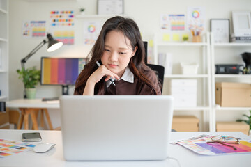 Young graphic designer focused on project in creative studio.