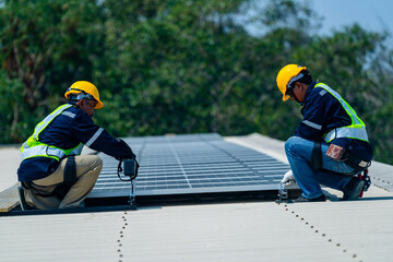 Two engineers install solar panels on a rooftop, wearing safety gear and helmets. The scene...