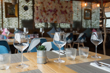 Elegant restaurant interior with empty tables and wine glasses