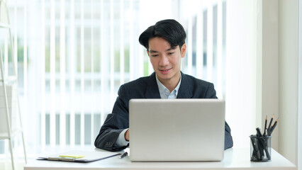 Confident businessman working from a bright and minimal office space, symbolizing innovation, leadership, and corporate success.