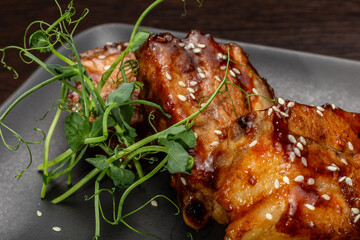 Stewed meat with sesame on a black plate, Japanese cuisine