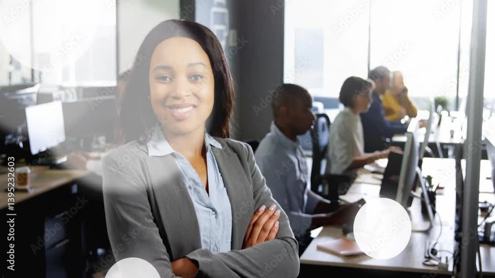 Aufkleber smiling businesswoman in office with colleagues working at computers in background