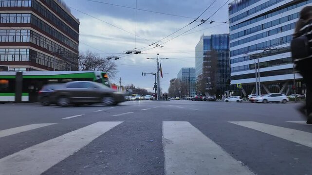 Fast-paced urban timelapse with pedestrians crossing street and speeding tram 4k
