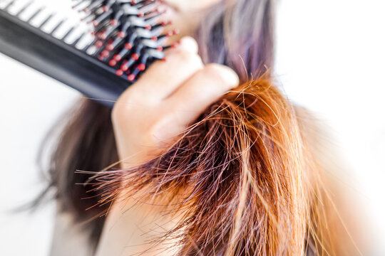Closeup portrait of female model holding messy hair in hands, Combing with brush and pulls long hair, Daily preparation for looking nice, Long Disheveled Hair, Holding Messy Hair