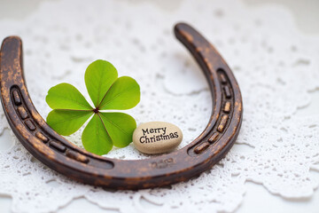 horseshoe with a four leaf clover next to it