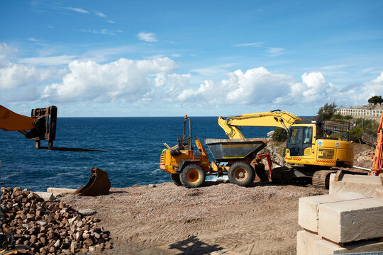 Heavy machinery at construction site by the sea