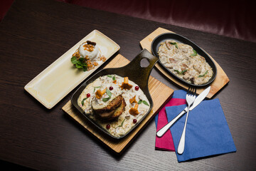 Set of potato pancakes with mushrooms, meat in sauce and dessert