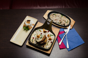 Set of potato pancakes with mushrooms, meat in sauce and dessert