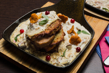 Draniki with chanterelle mushrooms, cream sauce and meat