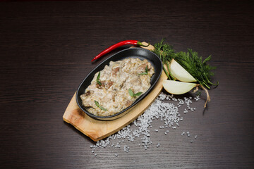Meat in a creamy sauce with mushrooms and cheese