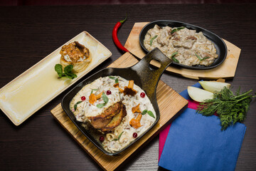 Set of potato pancakes with mushrooms, meat in sauce and dessert