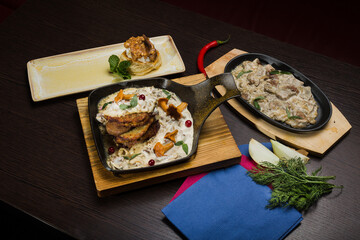 Set of potato pancakes with mushrooms, meat in sauce and dessert
