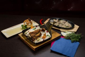 Set of potato pancakes with mushrooms, meat in sauce and dessert