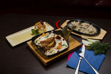 Set of potato pancakes with mushrooms, meat in sauce and dessert