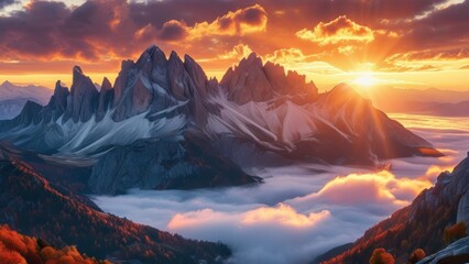 Obraz premium Mountain peaks bathed in the warm glow of sunrise above a sea of clouds.