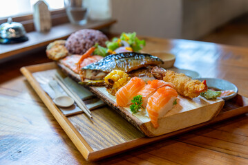 Japanese food set with salmon sushi grilled saba fish tempura and rice.