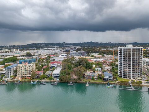Aerial view of hi rise buildings on a waterfront under dark storm clouds