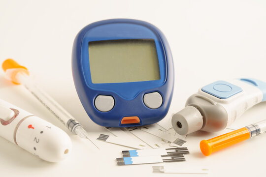 Glucometer lancet and  test strips testing blood sugar for diabetes.