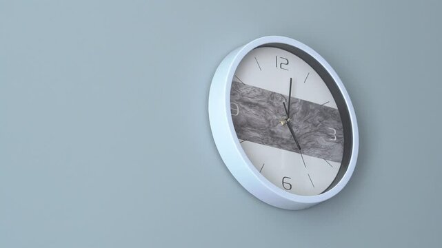 a clock with arrows hangs on a gray wall