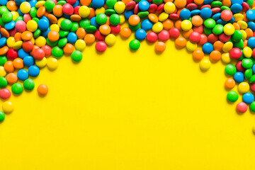 Mixed collection of colorful candy, on colored background. Flat lay, top view. frame of colorful chocolate coated candy