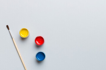 art palette with paint and brushes, close up. Top view with empty space. workplace for creativity. home teaching concept drawing