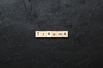 trauma word written on wood block. trauma text on table, concept