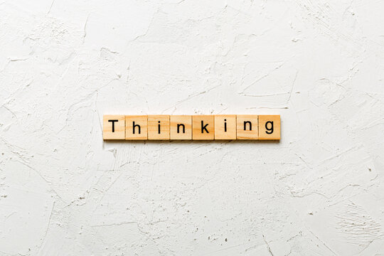 Naklejki thinking word written on wood block. thinking text on cement table for your desing, concept