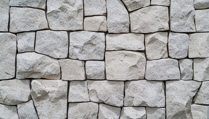 Fototapeta premium Textured crushed stone wall featuring embedded gravel, suitable for backgrounds or design projects.