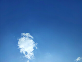 View Bright blue sky with white clouds