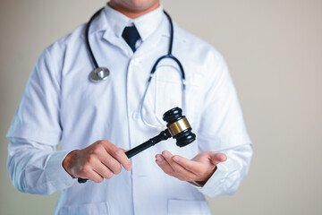 Medical Professional Holding Gavel Symbolizing Ethics in Governance