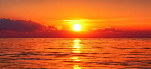 Obraz premium A stunning sunset over calm waters, showcasing vibrant oranges and yellows reflecting on the serene sea, ideal for nature lovers.
