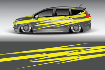 Sleek modified vehicle with vibrant yellow graphics parked against a gradient backdrop