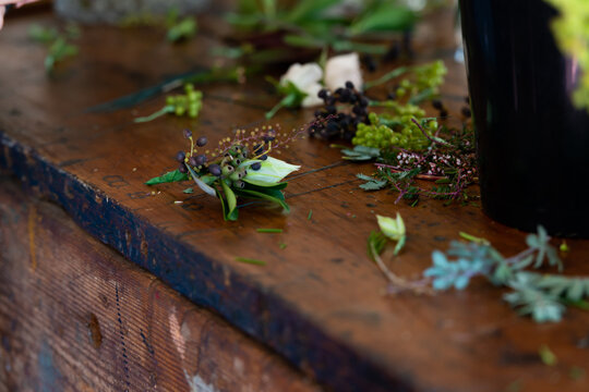 Elegant little wedding suit buttonhole or boutonnière on an old wooding work bench