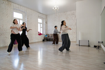 Dancing girls, group class in dance studio class, modern energetic dance	