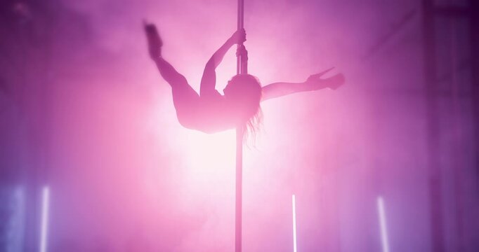 Neon light, pole dancing and woman with silhouette in nightclub, sexy and exotic choreography. Erotic dancer, performance and girl moving with flexibility, burlesque and spin for show with smoke