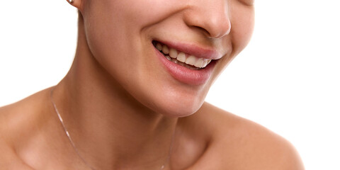 Obraz premium Cropped close-up image of young, smiling, beautiful woman with flawless, spotless skin, plump lips and white teeth. Concept of dental care, skincare, wellness, beauty treatment. Perfect chin line