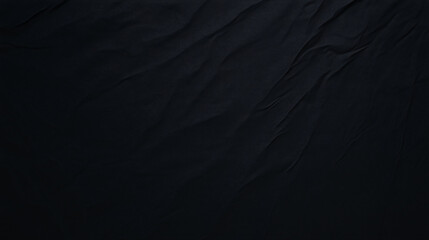 Rich black fabric with deep texture and subtle folds creates dramatic backdrop