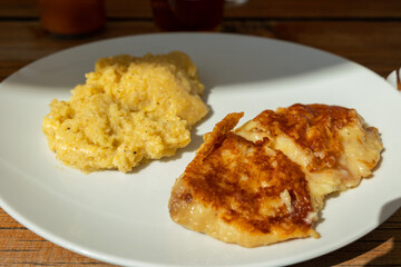 frico con polenta, piatto tradizionale della regione Friuli Venezia Giulia, nell'Italia nord-orientale, a base di farina di mais, patate e formaggio montasio