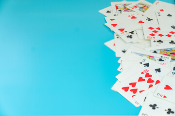 Many playing cards on aqua background.