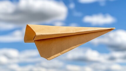 Tan Paper Airplane Soaring in a Blue Sky with White Clouds