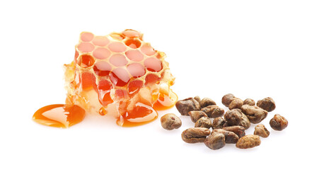 Propolis granule with honeycomb on white background