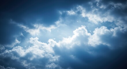 Fototapeta premium Dramatic clouds illuminated by sunlight, creating a moody atmosphere in the sky