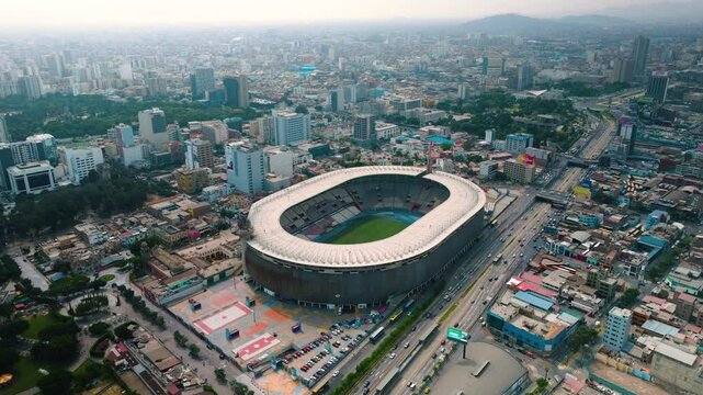 Aerial View of Estadio Nacional del Per&uacute; and Surrounding Area in Lima. This aerial footage captures the Estadio Nacional del Per&uacute; in Lima, showcasing the iconic stadium and the surrounding area