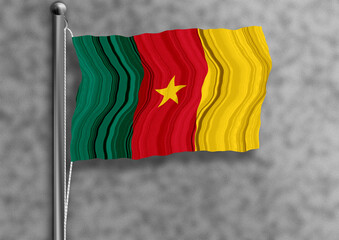 Cameroon flag flying on a flagpole, isolated, textured wall in the background.