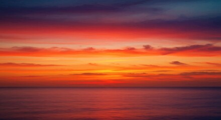 Fototapeta premium Vibrant sunset over calm ocean waters with colorful clouds reflecting in the sky