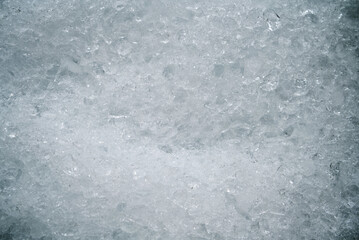 Crushed ice on a surface. Cold, textured, and ideal for abstract backgrounds or representing...